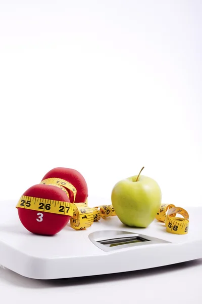 Green Apple & Freeweights Wrapped in a Tape Measure on a Scale — Stock Photo, Image