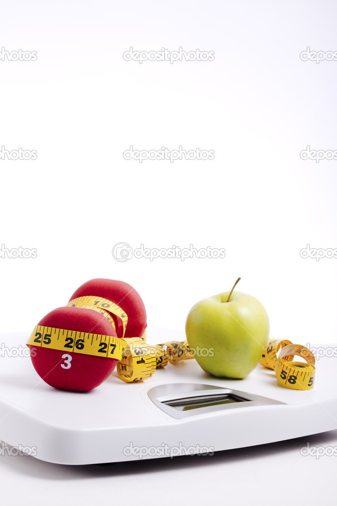 Green Apple & Freeweights Wrapped in a Tape Measure on a Scale
