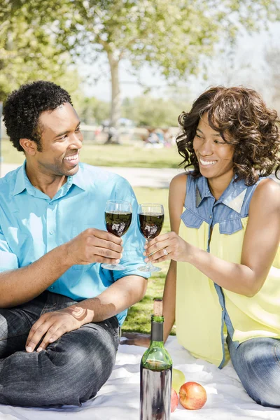 Onnellinen pari juominen viini puistossa — kuvapankkivalokuva