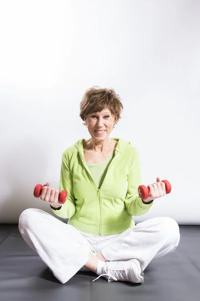 Mature Woman Exercising on a White Background — Stock Photo, Image