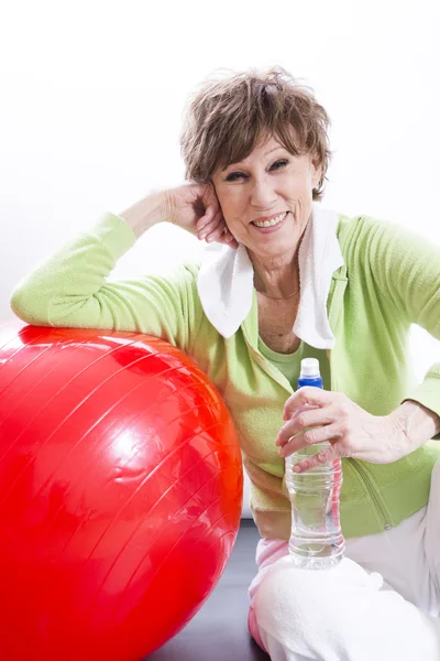 Mature Woman Exercising on a White Background — Stock Photo, Image