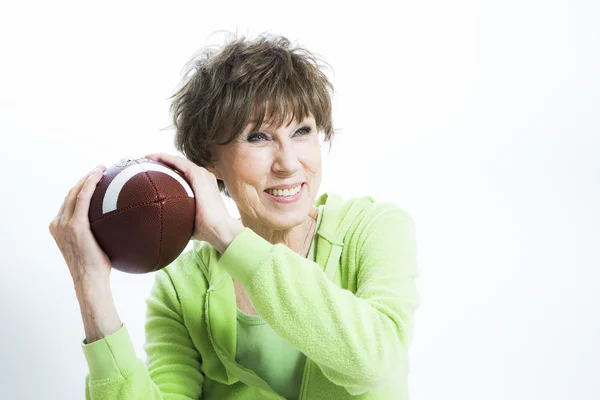 Mature Woman Throwing a Football — Stock Photo, Image