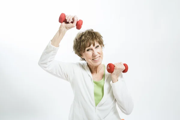 Mature Woman Exercising on a White Background — Stock Photo, Image