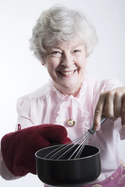 Elderly Woman Holding a Pot and Whisk — Stock Photo, Image