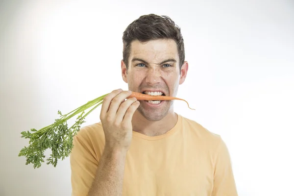 Man Biting a Carrot — Stock Photo, Image