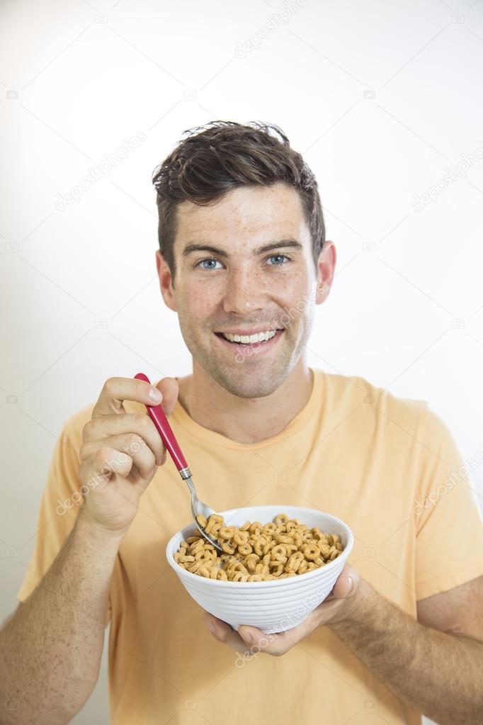 Man Eating a Bowl of Cereal Stock Photo by ©ZOOMYimages 35879599
