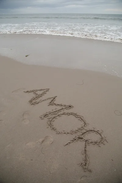 "아모르" 모래에 쓰여진 스톡 사진