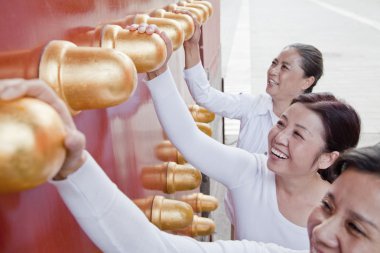 Women standing next to the traditional Chinese door clipart