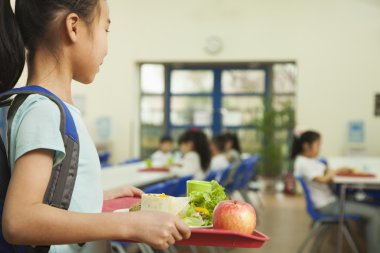 School girl in school cafeteria clipart