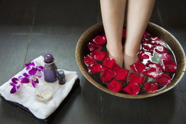 Woman's Feet in Water with Rose Petals clipart