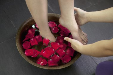 Woman's Feet in Water with Rose Petals clipart