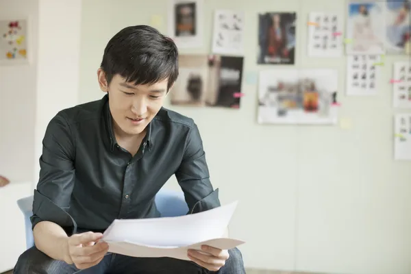 Professional Man Looking at Papers in Office — Stock Photo, Image