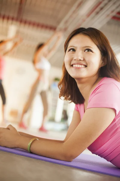 Jeunes femmes assises sur des tapis de yoga — Photo