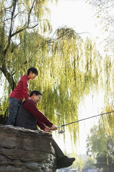Grandfather and grandson fishing portrait at lake — Stock Photo, Image