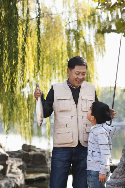 Grandfather and grandson fishing — Stock Photo, Image