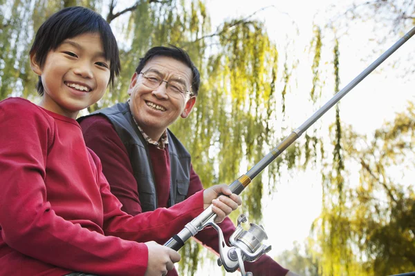 Grandfather and grandson fishing portrait at lake — Stock Photo, Image
