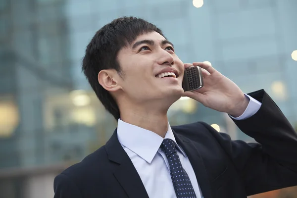 Businessman on the phone looking up — Stock Photo, Image