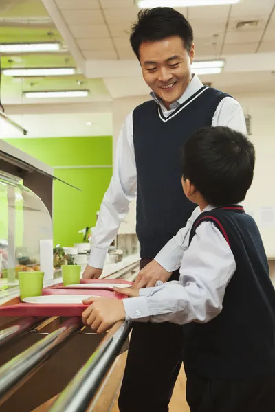 Teacher and student in school cafeteria — Stock Photo, Image