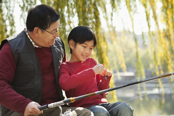 Grandfather and grandson fishing portrait at lake — Stock Photo, Image