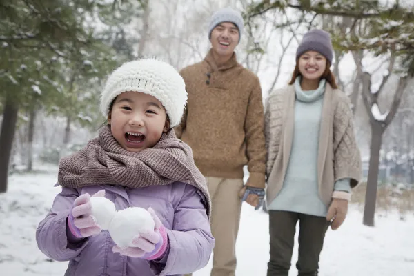 Girl carrying snow balls — Stock Photo, Image