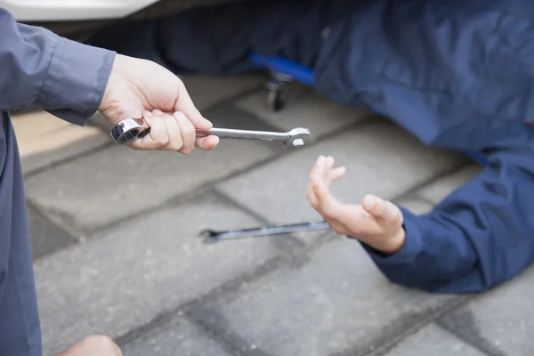 Mechanic giving a Wrench to Male Mechanic — Stock Photo, Image