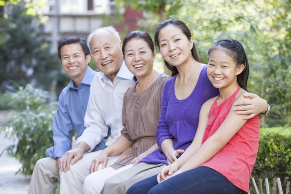 Three Generation Family Sitting in their Apartment Courtyard — Stock Photo, Image