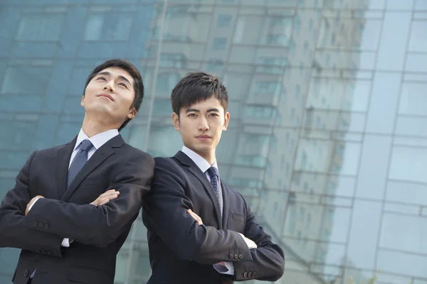 Businessmen outside glass building — Stock Photo, Image