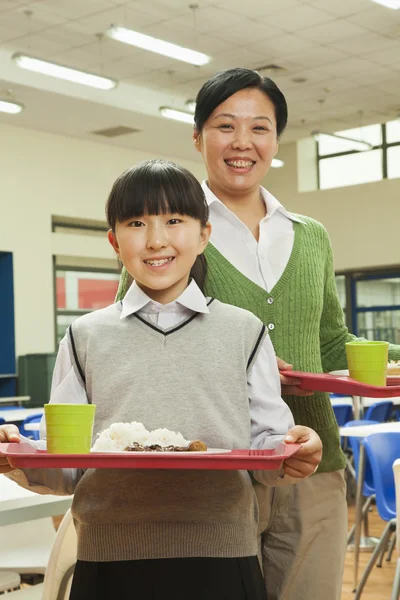 Portrait d'enseignante et d'écolière à la cafétéria scolaire — Photo