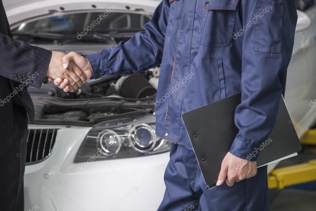 Businessman shaking hands with Mechanic Stock Photo by ©XiXinXing 36081781
