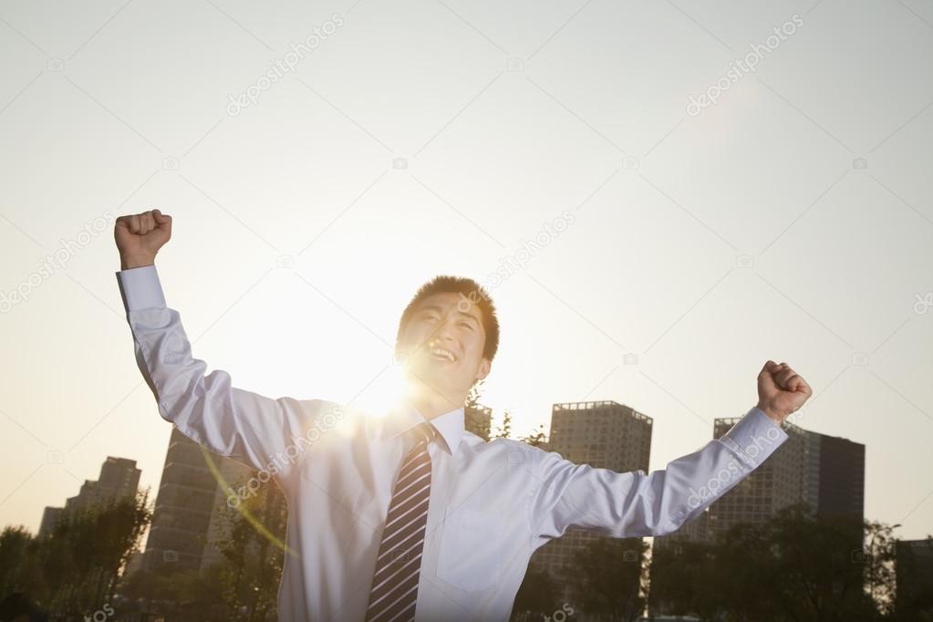 Businessman with fists in the air celebrating