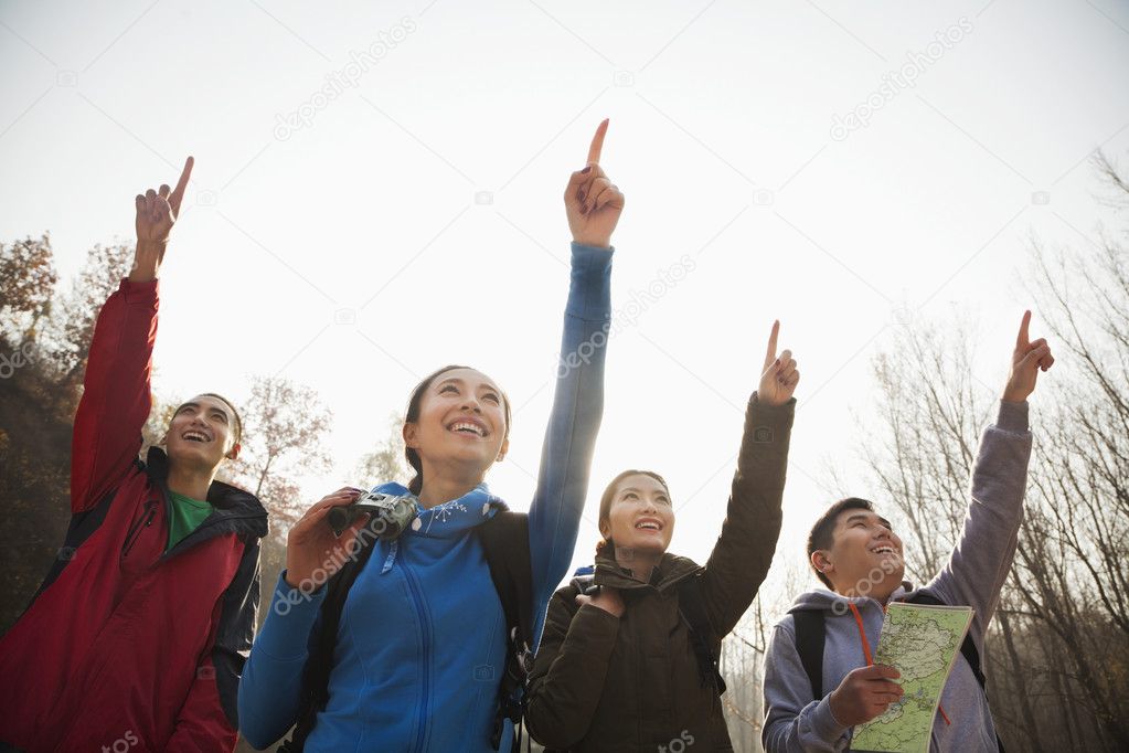 People pointing to the mountain top