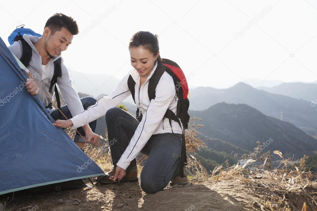 Couple setting up the tent