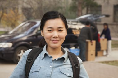 Student in front of dormitory at college clipart