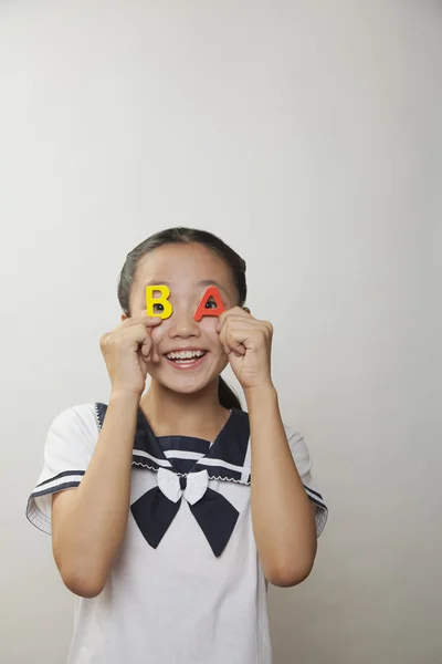 Girl holding plastic letters — Stock Photo, Image