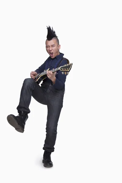 Young man with punk Mohawk playing guitar — Stock Photo, Image