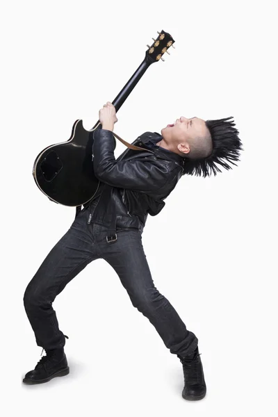 Young man with punk Mohawk playing guitar — Stock Photo, Image