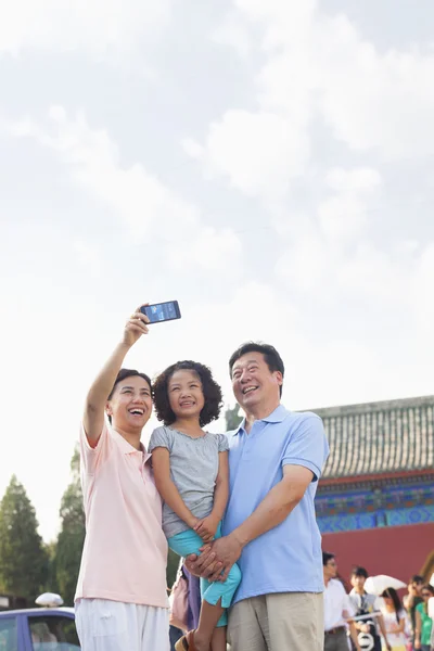 Grandparents and granddaughter taking self portrait — Stock Photo, Image