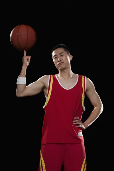 Basketball player spinning ball with one finger — Stock Photo, Image