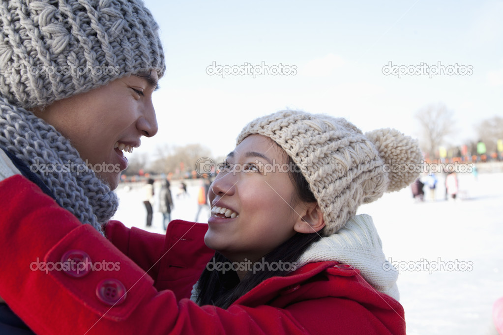Couple hugging at ice rink