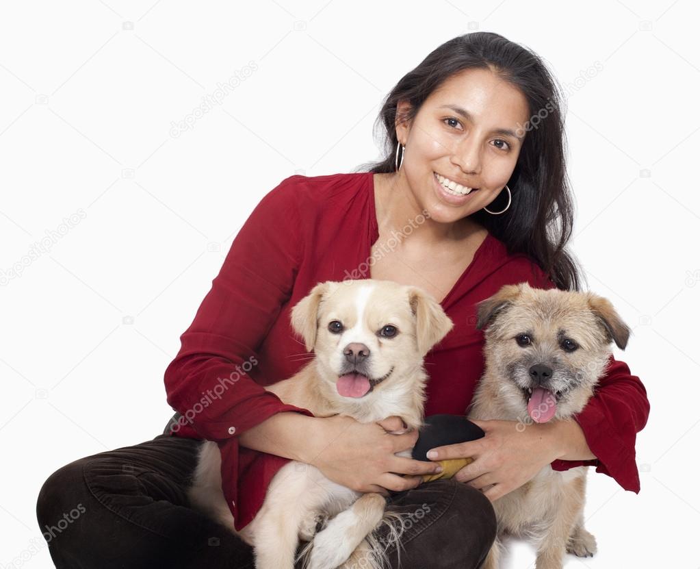 Woman embracing her dogs