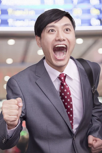 Businessman running through airport — Stock Photo, Image
