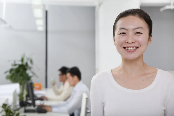 Businesswoman smiling in the office — Stock Photo, Image