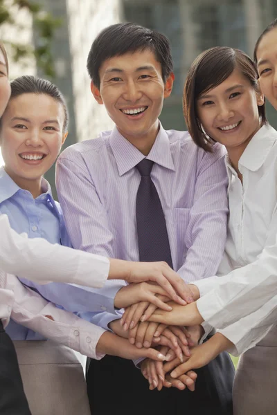 Young business people with hands on top of each other — Stock Photo, Image