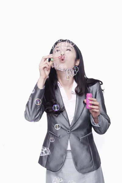 Businesswoman making bubbles — Stock Photo, Image