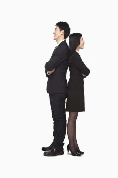 Businessman and businesswomen standing back to back — Stock Photo, Image