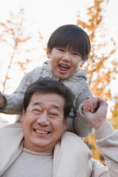 Grandfather Carrying Grandson — Stock Photo, Image