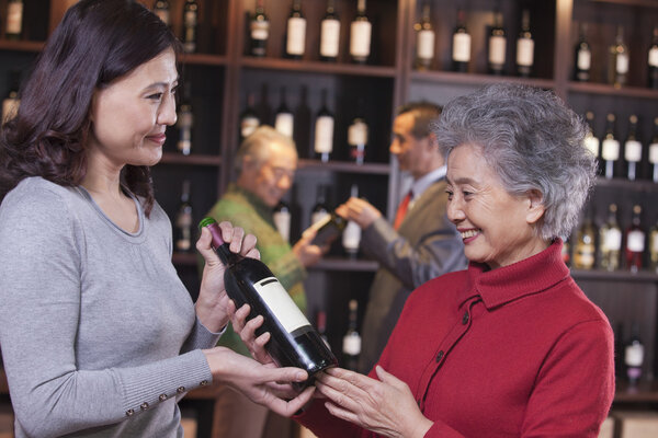 Women Examining Wine at a Wine Store