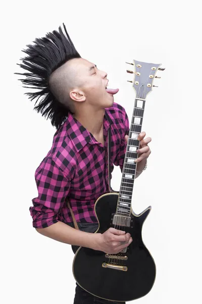 Young man with punk Mohawk playing guitar — Stock Photo, Image