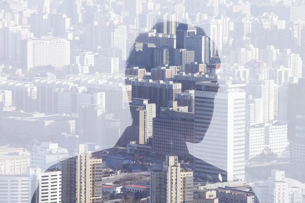 Double exposure of man over cityscape — Stock Photo, Image