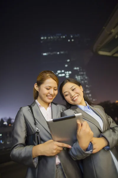 Businesswomen looking at digital tablet — Stock Photo, Image